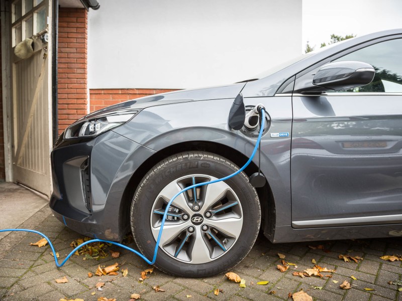 An electric vehicle plugged into a charger.