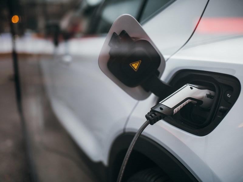 A charging cable plugged into an electric vehicle