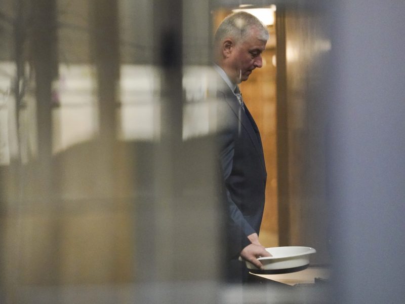 Former Ohio House Speaker Larry Householder waits to retrieve his personal items after going through security at Potter Stewart U.S. Courthouse before jury selection in his federal trial, Friday, Jan. 20, 2023, in Cincinnati.