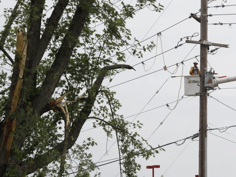 Utility workers address damaged power poles in May 2019, in Vandalia, Ohio, in the aftermath of strong tornadoes that spun through the Midwest.