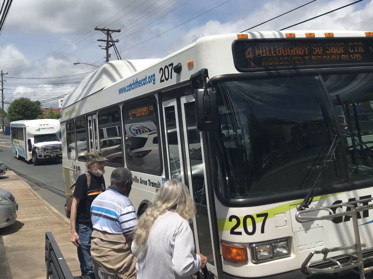 Passengers boarding a Charlottesville Area Transit bus.