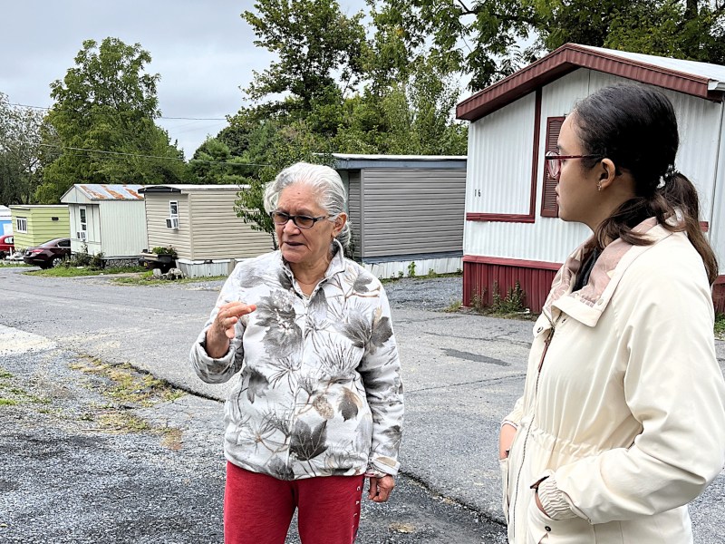 Leoncia Cabrera discusses some of her home’s shortcomings last fall with Hilda Garcia, a program support specialist with Energy Solutions team at Community Housing Partners.