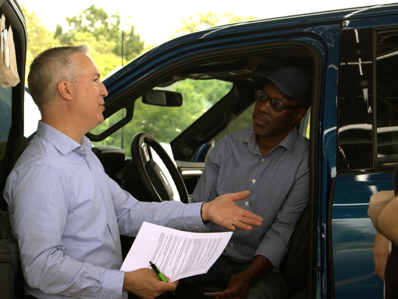 Michael Benson, vice president of Drive Electric Northeast Ohio, talks with Keith Benford, right, who attended the Route Zero Road Trip event.