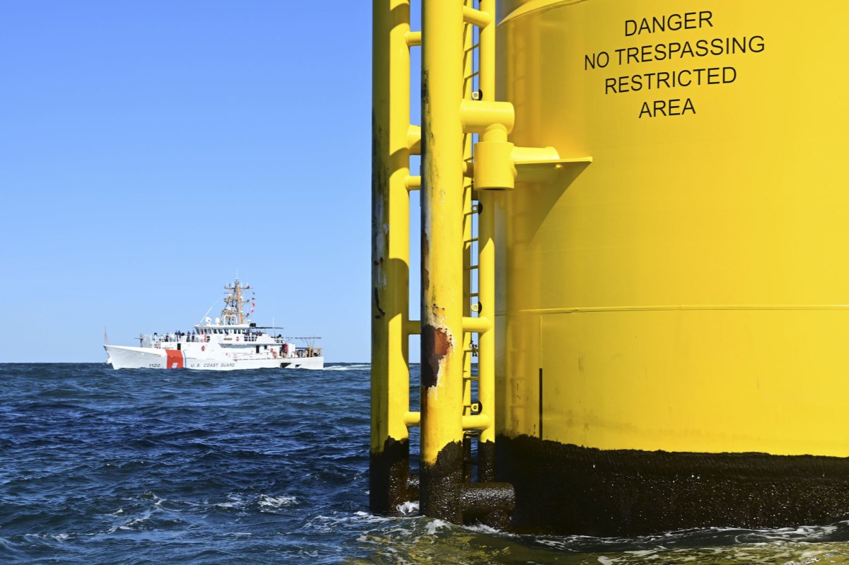 A Coast Guard ship near an offshore wind turbine off the coast of Virginia.