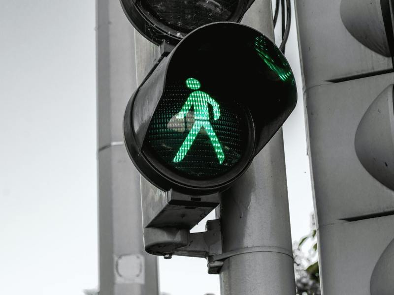 A walk sign, illuminated green.