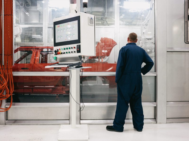 Rivian's R1T electric truck makes its way through the paint shop at the company's Normal, Illinois, manufacturing plant.