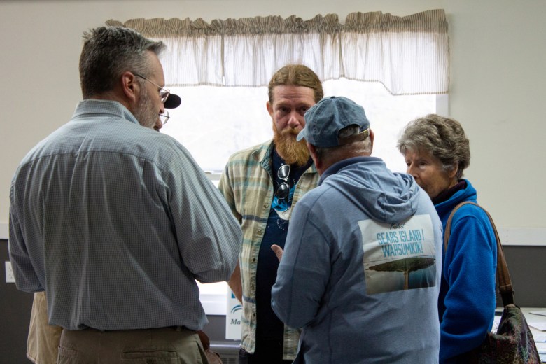 Opponents of an offshore wind port planned for Sears Island, Maine, talk to organizers from the Maine Labor Climate Council at a dinner in Searsport on May 14.