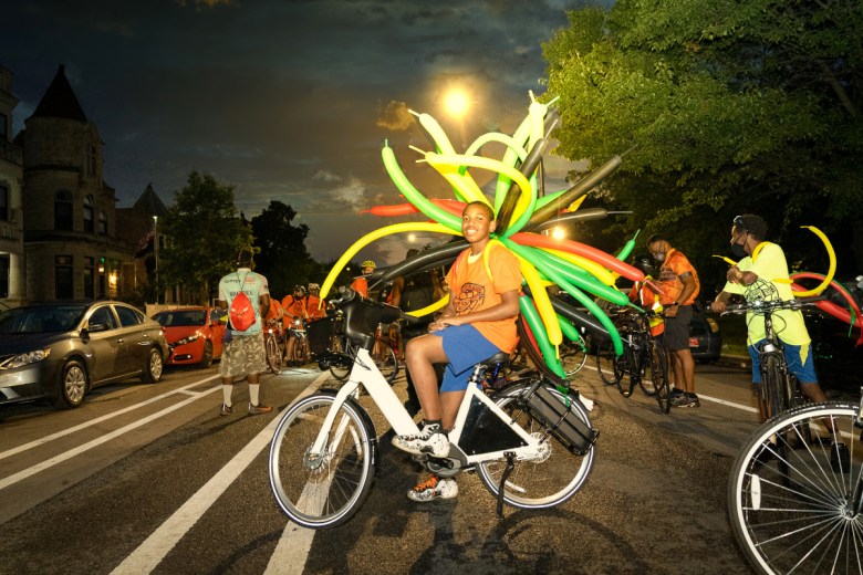 Teen on bike with balloons