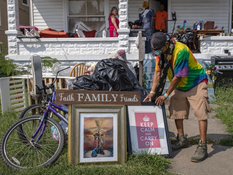 A tenant packs up items as an eviction is enforced at his home.