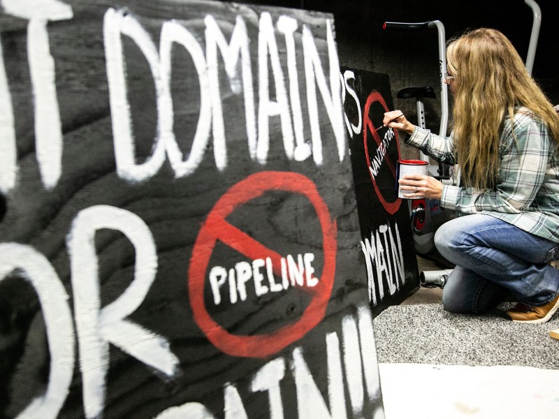 Residents opposed to a multi-state carbon pipeline gathered in Linn County, Iowa, to paint signs protesting the project in December 2021.